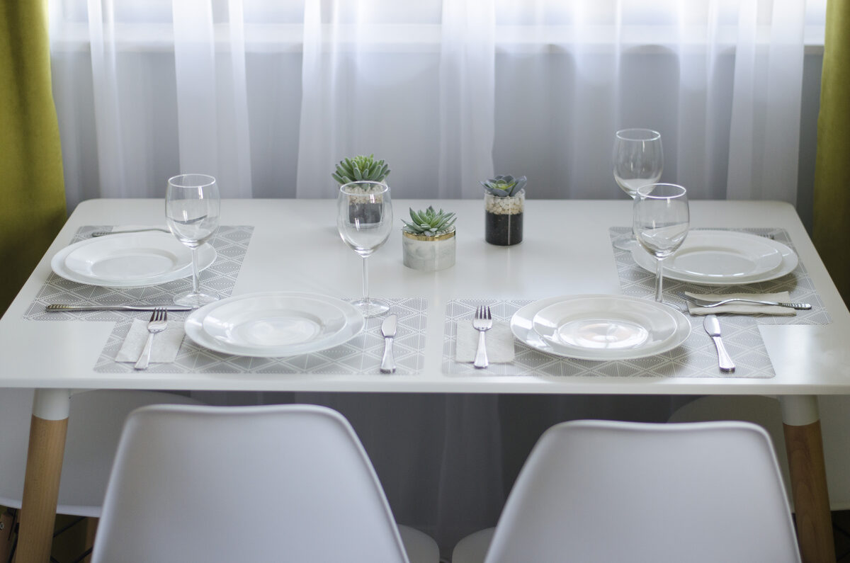 Elegant table setting with wine glasses and succulent centerpieces