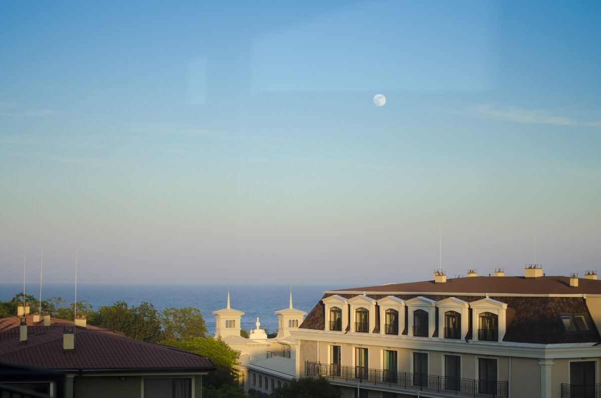 Evening balcony view with moon, Black Sea horizon, and resort architecture