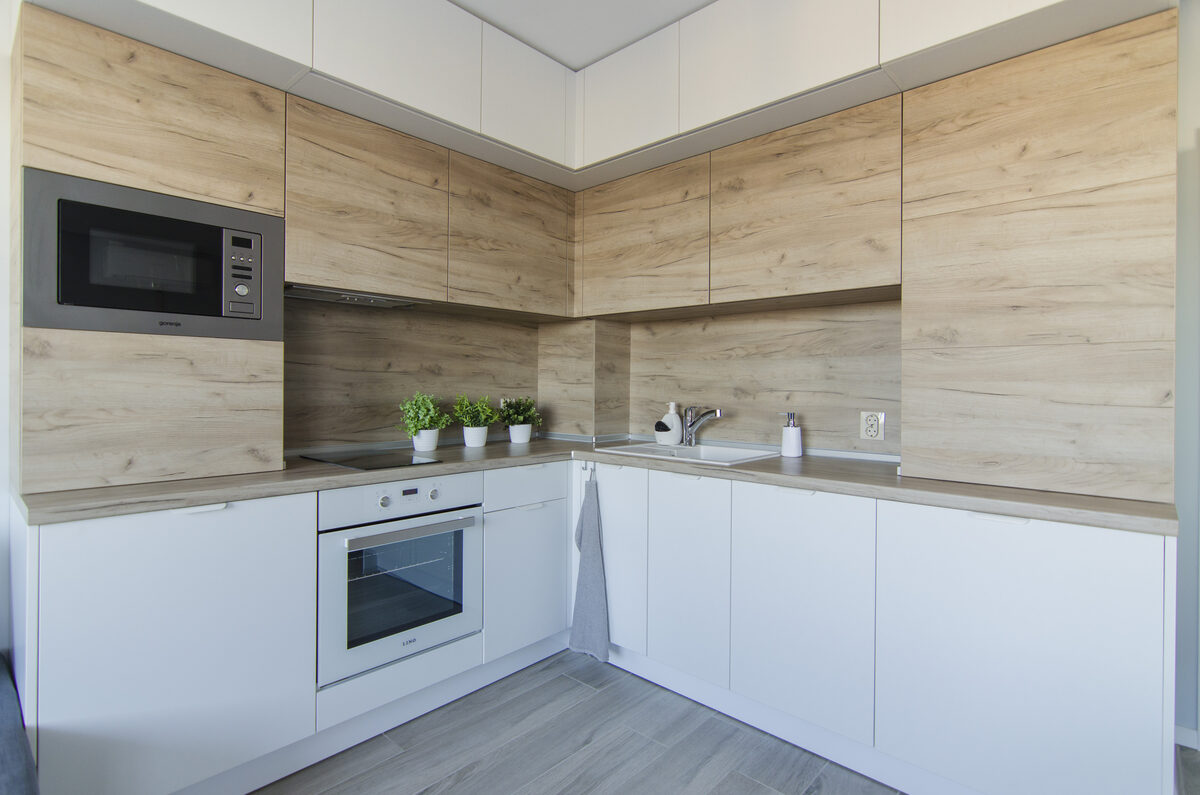 Modern kitchen with LED strip lighting, built-in microwave, and herb planters